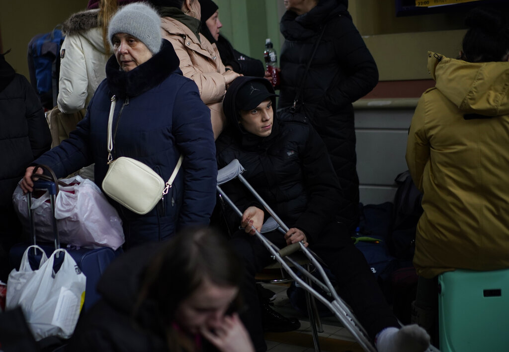 People, who have fled from Ukraine, wait in the train station in Przemysl, Poland, Tuesday, March 8, 2022. U.N. officials said Tuesday that the Russian onslaught has forced 2 million people to flee Ukraine. It has trapped others inside besieged cities that are running low on food, water and medicine amid the biggest ground war in Europe since World War II. (AP Photo/Daniel Cole)