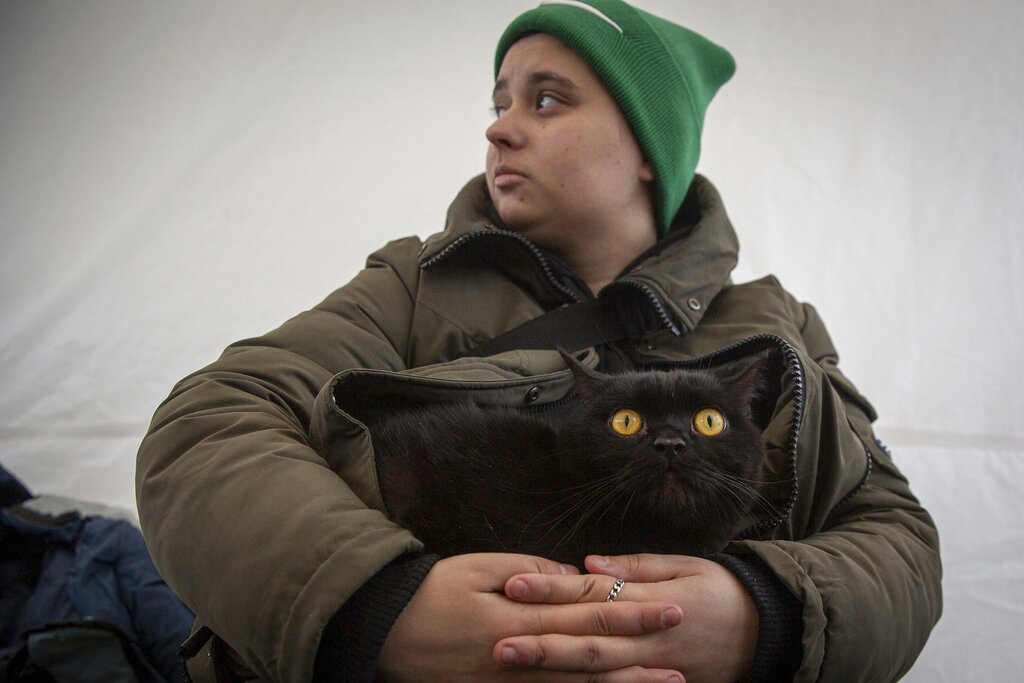 Natasha Ukrainec, holds her cat Bonja, after fleeing Kharkiv, Ukraine at the border crossing in Medyka, Poland, Poland, Tuesday, March 8, 2022. Russia's invasion of Ukraine has set off the largest mass migration in Europe in decades, with more than 1.5 million people having crossed from Ukraine into neighboring countries. (AP Photo/Visar Kryeziu)