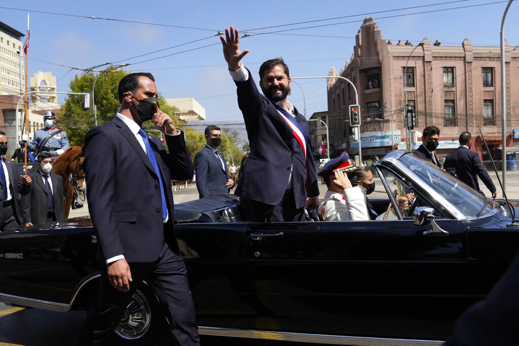 Chile's new President Gabriel Boric waves from a car on his inauguration day in Valparaiso, Chile, Friday, March 11, 2022. (AP Photo/Natacha Pisarenko)
