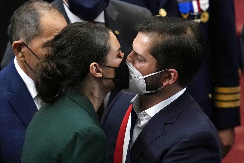 Chile's new President Gabriel Boric kisses his partner Irina Karamanos after his swearing-in ceremony at Congress in Valparaiso, Chile, Friday, March 11, 2022. (AP Photo/Esteban Felix)