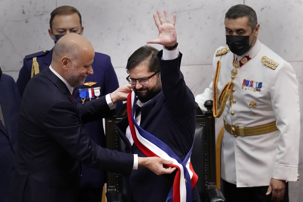 Chile's new President Gabriel Boric receives the presidential sash from Congress President Alvaro Elizalde during his swearing-in ceremony at Congress in Valparaiso, Chile, Friday, March 11, 2022. (AP Photo/Esteban Felix)