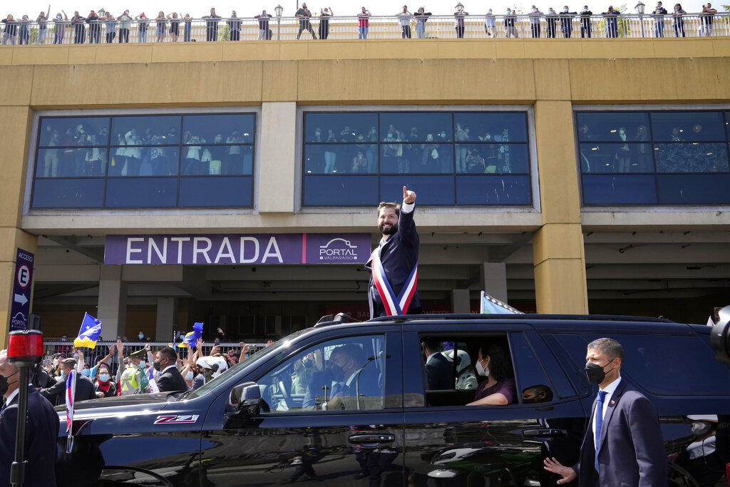 Chile's new President Gabriel Boric points from the car after his swearing-in ceremony at Congress in Valparaiso, Chile, Friday, March 11, 2022. (AP Photo/Natacha Pisarenko)