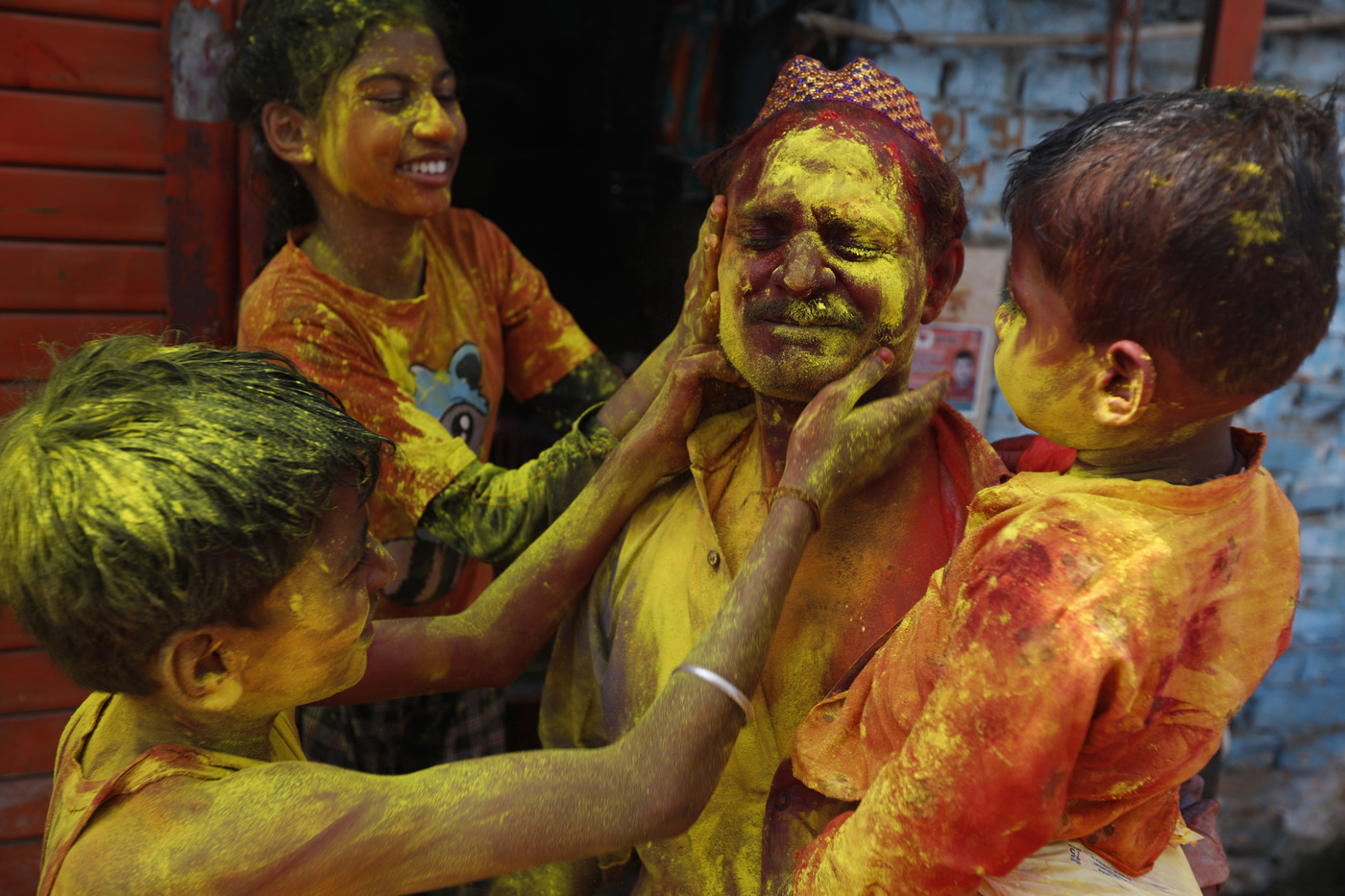 People celebrate Holi in Prayagraj, in the northern Indian state of Uttar Pradesh, Friday, March 18, 2022. The festival, a celebration of warm weather, good harvests and the defeat of evil, brings out millions of people, from toddlers to the elderly, to throw powder at one another and play with water balloons and squirt guns. (AP Photo/Rajesh Kumar Singh)