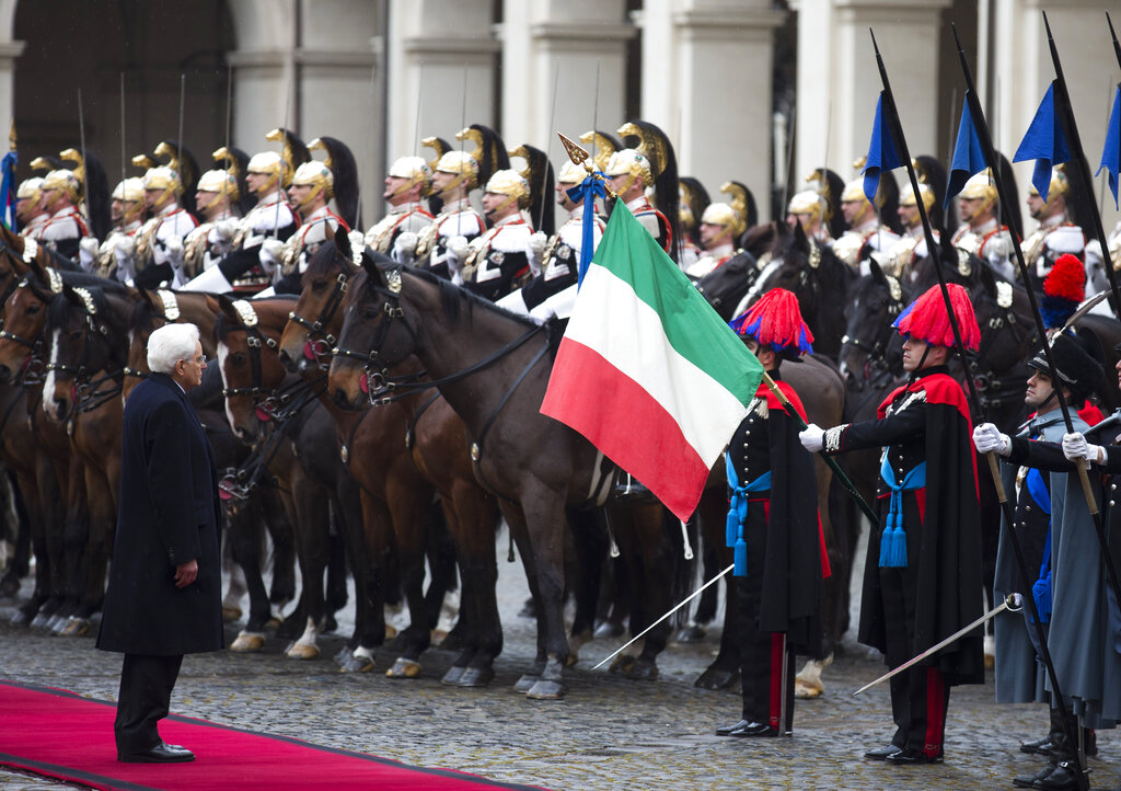 Newly elected Italian President Sergio Mattarella, left, reviews the Cuirassier presidential horse guards during the ceremony to start his seven years as Italy's President at the Quirinal presidential palace in Rome, Tuesday, Feb. 3, 2015. Italy's new president, Sergio Mattarella, has taken the oath of office with a vow to fight corruption and organized crime and encourage the nation to embrace economic and electoral reform. The new head of state, whose brother, Piersanti Mattarella, was slain while governor of Sicily by the Mafia in 1980, denounced as 