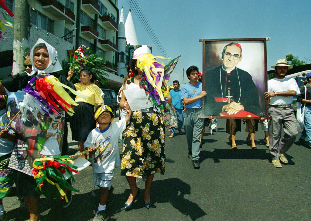 A portrait of Monsignor Oscar Arnulfo Romero, Archbishop of El Salvador, is carried down a street in the capital city of San Salvador as hundreds marched to mark the 14th anniversary of his assassination, March 24, 1994.  A gunman shot and killed Romero as he celebrated mass in 1980.  The Roman Catholic church has begun the lengthy process of gathering evidence to beatify Romero.  (AP Photo/John McConnico)