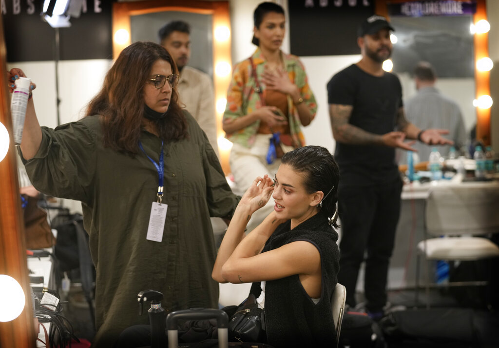 A model checks her make-up backstage as she prepares to walk the ramp during 'FDCI X Lakme Fashion Week' in New Delhi, Thursday, March 24, 2022. (AP Photo/Manish Swarup)
