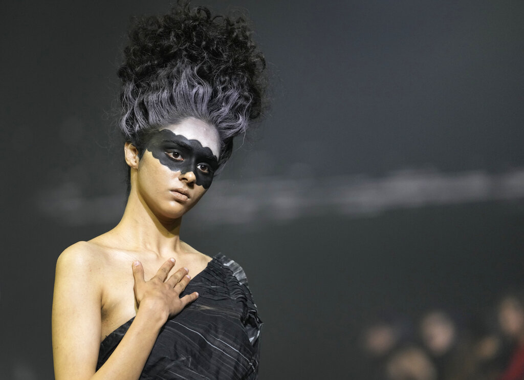 A model displays a creation by Indian designer Nitin Bal Chauhan called countdown during the 'FDCI X Lakme Fashion Week' in New Delhi, Thursday, March 24, 2022. Countdown is a conceptual collection design to raise awareness on how our collective action and non-sustainable growth is leading our planet to a point of no return, according to a press release. (AP Photo/Manish Swarup)