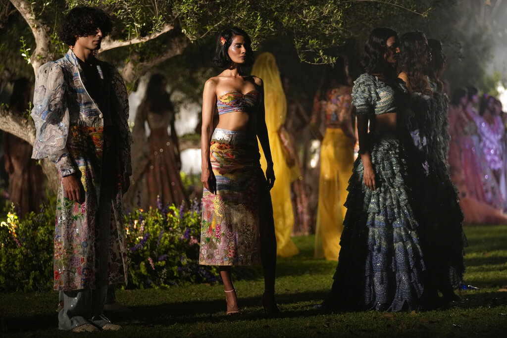 Models display creations of Indian designer Rahul Mishra on the opening day of 'FDCI X Lakmé Fashion Week' at the Italian embassy in New Delhi, Tuesday, March 22, 2022. (AP Photo/Manish Swarup)