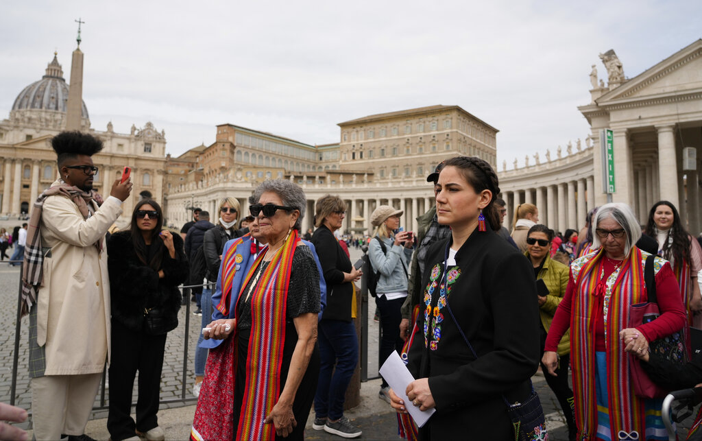 President of the Metis community, Cassidy Caron, second from right, arrives to speak to the media in St. Peter's Square after their meeting with Pope Francis at The Vatican, Monday, March 28, 2022. (AP Photo/Gregorio Borgia)