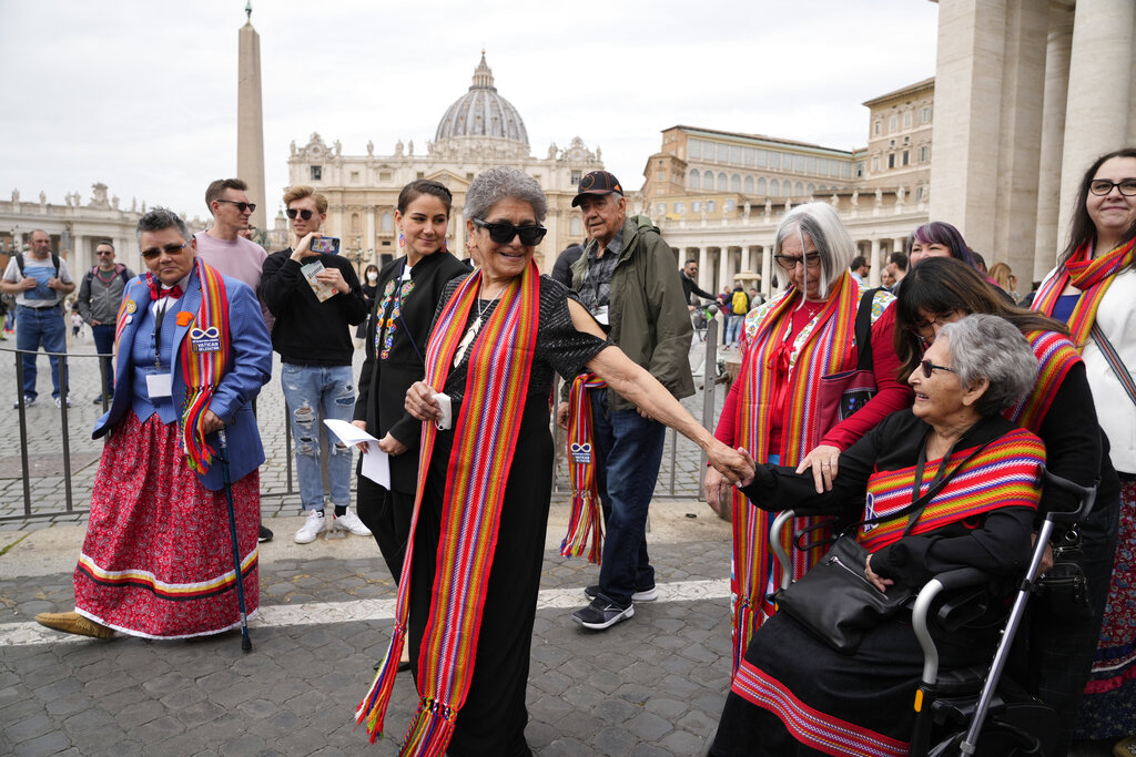 President of the Metis community, Cassidy Caron, at center in black outfit, and other delegates arrive to speak to the media in St. Peter's Square after their meeting with Pope Francis at The Vatican, Monday, March 28, 2022. (AP Photo/Gregorio Borgia)