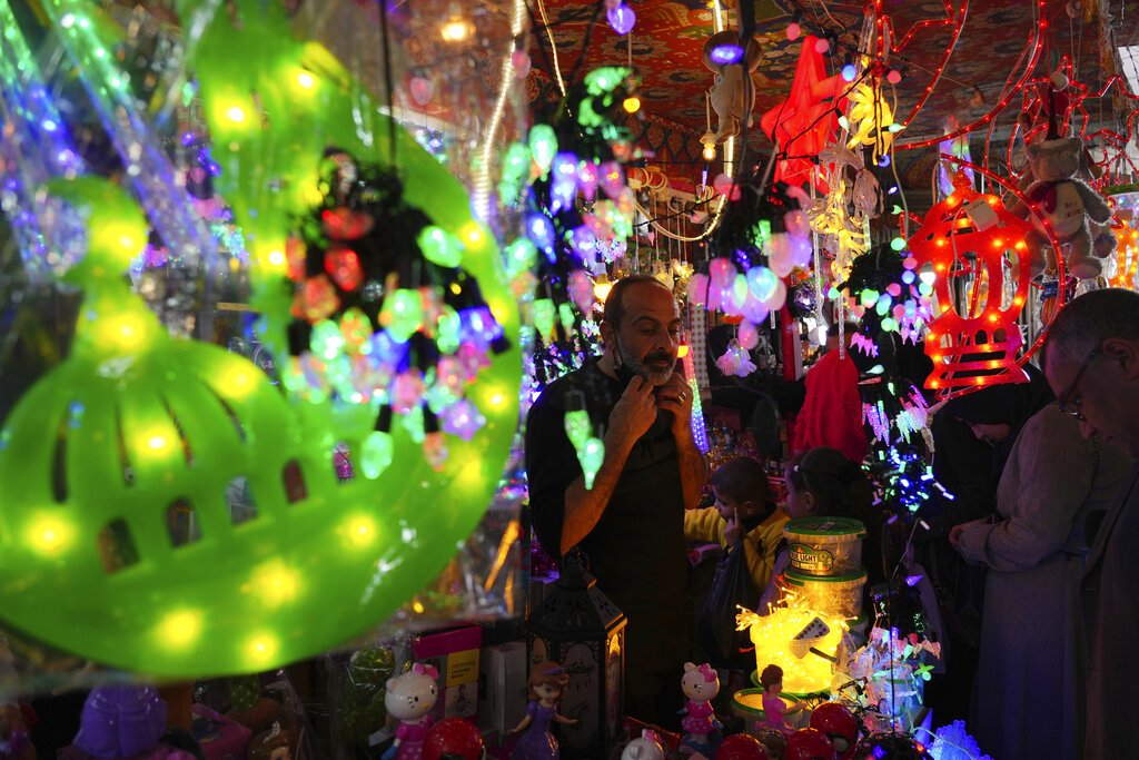 People shop decorations for the Muslim holy month of Ramadan, at al-Zawya traditional market in Gaza City, Thursday, March 31, 2022. As Ramadan begins with the new moon next week, Muslims around the world are trying to maintain their religious rituals of Islamic holiest month. (AP Photo/Adel Hana)