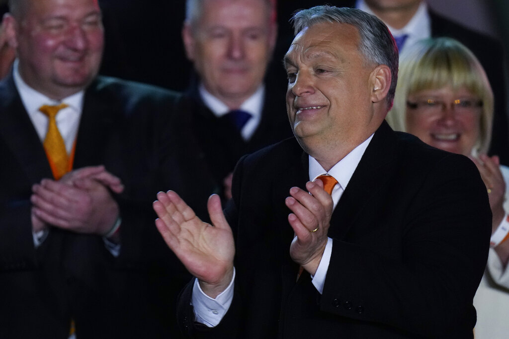 Hungary's Prime Minister Viktor Orban acknowledges cheering supporters during an election night rally in Budapest, Hungary, Sunday, April 3, 2022. Early partial results in Hungary's national election are showing a strong lead for the right-wing party of pro-Putin nationalist Orban as he seeks a fourth consecutive term. (AP Photo/Petr David Josek)