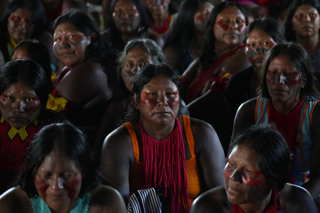 Xikrin Indigenous women attend a ceremony called the Meeting of the First Peoples at the 18th annual Free Land Indigenous Camp in Brasilia, Brazil, Friday, April 8, 2022. The 10-day event aims to show the unity of Brazil's Indigenous peoples in their fight for the demarcation of their lands and their rights. (AP Photo/Eraldo Peres)