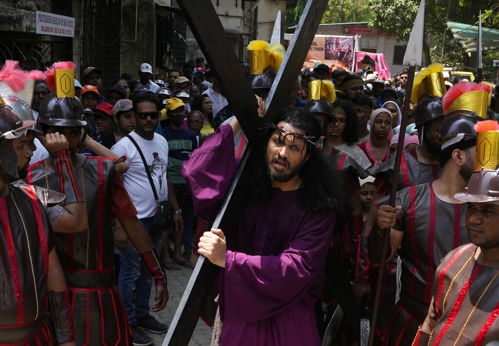 A man reenacts the crucifixion of Jesus Christ to mark Good Friday in Mumbai, India, Friday, April 15, 2022. Christians all over the world attend mock crucifixions and passion plays that mark the day Jesus was crucified, known to Christians as Good Friday. (AP Photo/ Rajanish Kakade)