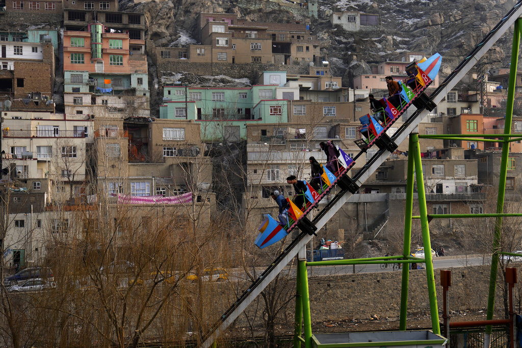 Afghan people enjoy a ride on a roller coaster, in Kabul, Afghanistan, Friday, Feb. 18, 2022. (AP Photo/Hussein Malla)