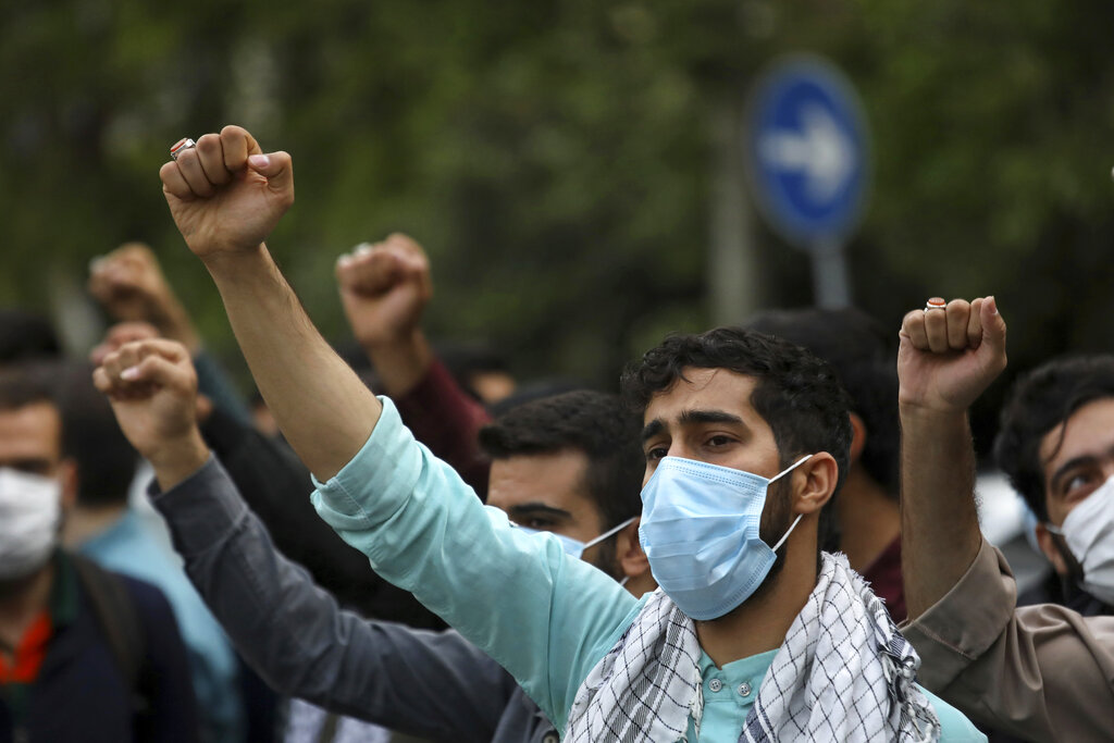 Protesters chant slogans during a demonstration to condemn planned Quran burnings by a right-wing group in Sweden, in front of the Swedish Embassy in Tehran, Iran, Monday, April 18, 2022. Sweden has seen unrest, scuffles and violence since Thursday, triggered by Danish far-right politician Rasmus Paludan's meetings and planned Quran burnings across the country. (AP Photo/Vahid Salemi)
