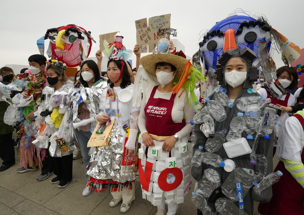 Environmental activists wearing outfits made from plastic waste participate in a campaign to mark Earth Day against climate change in Seoul, South Korea, Friday, April 22, 2022. (AP Photo/Ahn Young-joon)