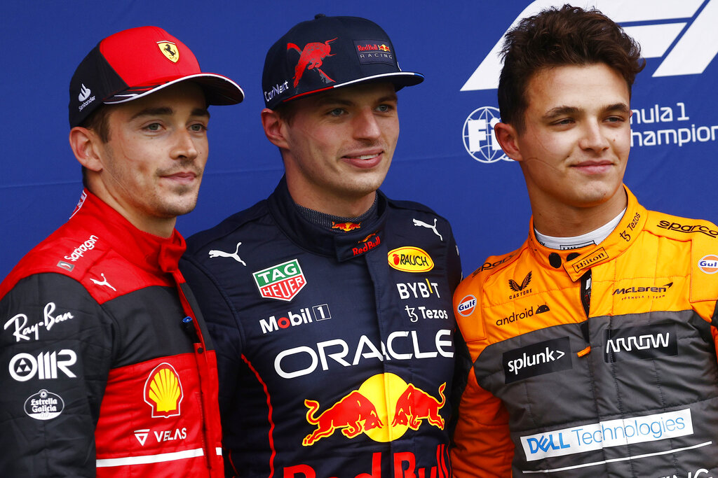Red Bull driver Max Verstappen, center, of the Netherlands, smiles after clocking a fastest time with second fastest time Ferrari driver Charles Leclerc, left, of Monaco, and third fastest time Mclaren driver Lando Norris, of Britain, during the qualifying session for Sunday's Emilia Romagna Formula One Grand Prix, at the Dino and Enzo Ferrari racetrack in Imola, Italy, Friday, April 22, 2022. (Guglielmo Mangiapane, Pool via AP)