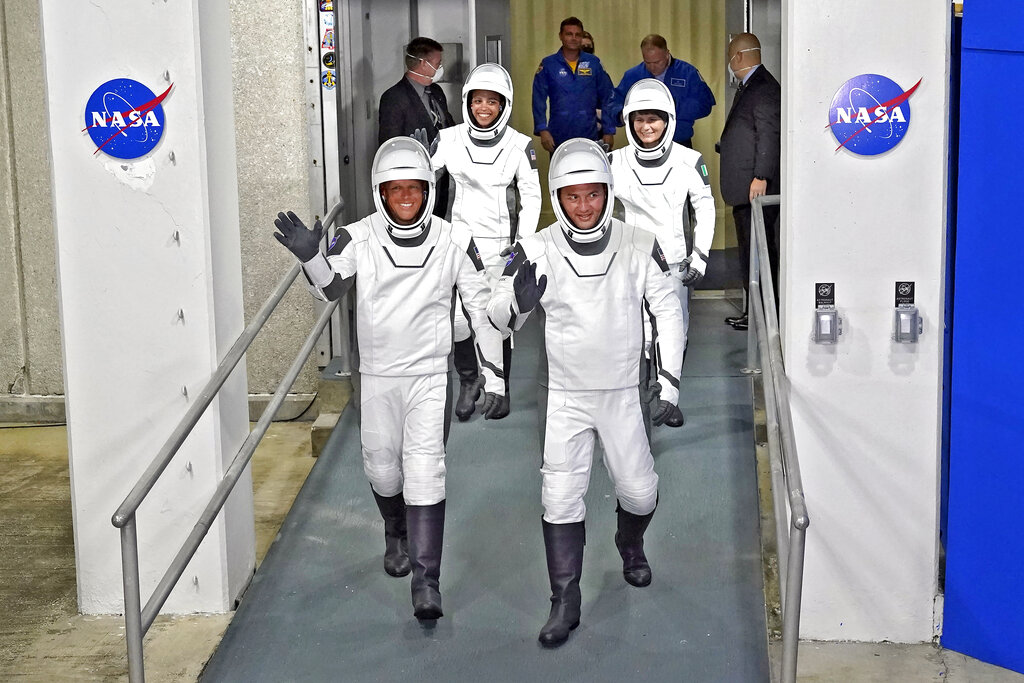 SpaceX Crew-4 astronauts, from left, pilot Bob Hines, mission specialist Jessica Watkins, commander Kjell Lindgren, and European Space Agency astronaut Samantha Cristoforetti, of Italy, wave as they leave the Operations and Checkout Building for a trip to Launch Complex 39-A Wednesday, April 27, 2022, at the Kennedy Space Center in Cape Canaveral, Fla. The four astronauts will fly to the International Space Station. (AP Photo/John Raoux)
