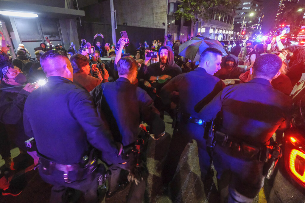 Demonstrators confront police officers near Pershing Square after protesting outside the U.S. Courthouse in response to leaked draft of the Supreme Court's opinion to overturn Roe v. Wade in Los Angeles, Tuesday, May 3, 2022. (AP Photo/Ringo H.W. Chiu)