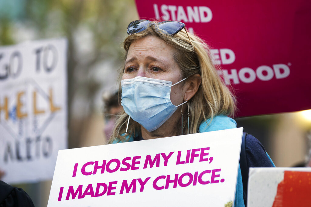 Martha Kreeger is overcome with emotion while standing alongside abortion-rights activists and supporters during a protest outside of the Ronald V. Dellums Federal Building in Oakland, Calif., Tuesday, May 3, 2022, in response to the leak of a draft opinion on a potential Supreme Court vote to overturn Roe v. Wade. (Jessica Christian/San Francisco Chronicle via AP)