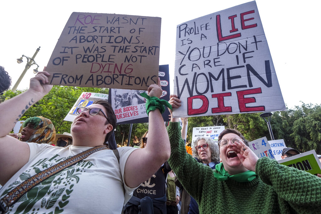 Demonstrators protest outside of the U.S. Courthouse in response to a leaked draft of the Supreme Court's opinion to overturn Roe v. Wade, in Los Angeles, Tuesday, March 3, 2022. (AP Photo/Ringo H.W. Chiu)