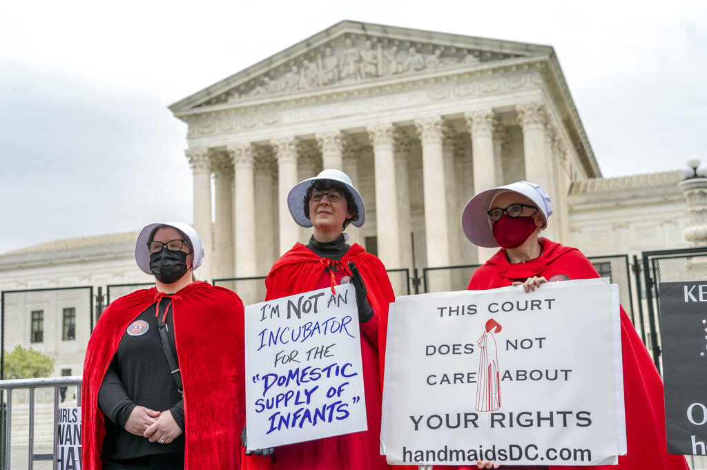 Abortion-rights protesters display placards during a demonstration outside the U.S. Supreme Court, Sunday, May 8, 2022, in Washington. (AP Photo/Gemunu Amarasinghe)
