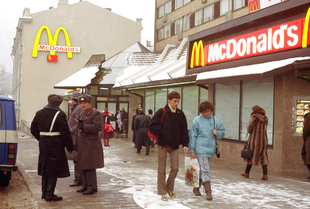 FILE - People walk past Moscow's first McDonalds a day before its opening, in Moscow's Pushkin Square, Jan. 30, 1990. Two months after the Berlin Wall fell, McDonald’s opened its doors in the middle of Moscow. It was the first American fast-food restaurant to enter the Soviet Union. But now, McDonald's is temporarily closing its 850 restaurants in Russia in response to the Ukraine invasion.  (AP Photo/Vicktor Yurchenko, File)