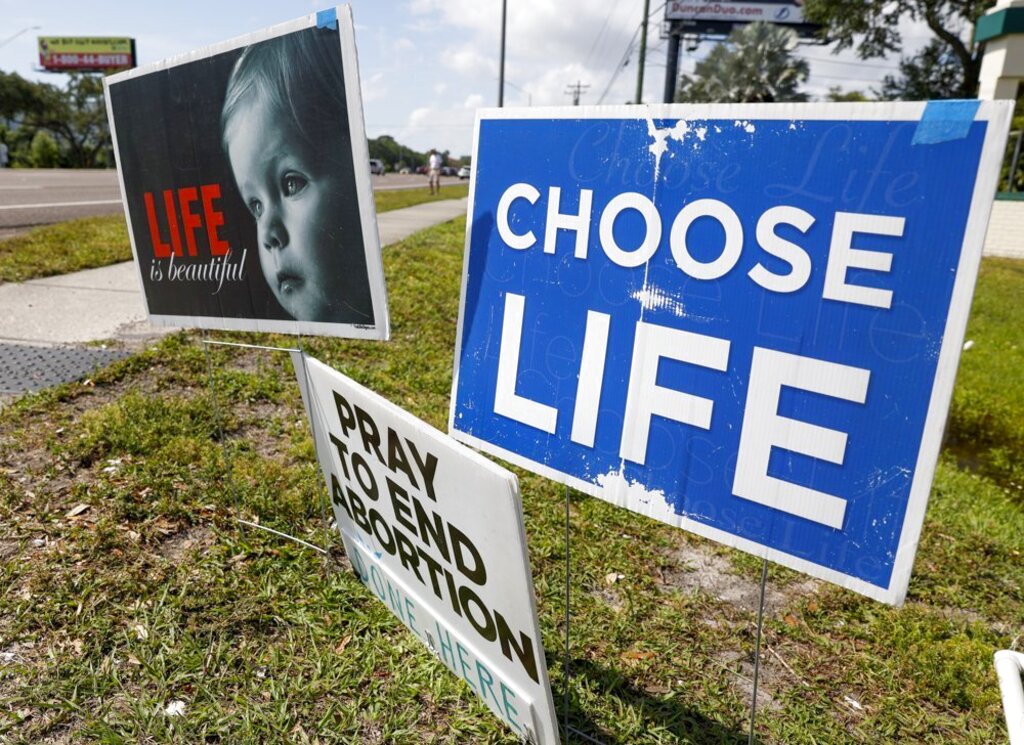Pro life signs are seen outside the All Women's Health Center of Clearwater on Tuesday, May 3, 2022. A draft of a U.S. Supreme Court brief was leaked Monday that suggests the court could be poised to overturn the landmark 1973 Roe v. Wade case. (Chris Urso/Tampa Bay Times via AP)