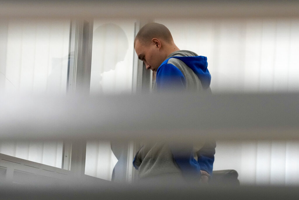 Russian Sgt. Vadim Shishimarin attends a court hearing in Kyiv, Ukraine, Monday, May 23, 2022. The 21 year old soldier facing the first war crimes trial since the start of the war in Ukraine plead guilty on May 18 to killing an unarmed civilian. (AP Photo/Natacha Pisarenko)