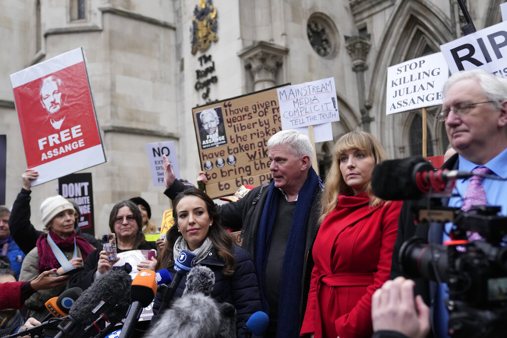 Julian Assange's partner Stella Moris, and Wikileaks Editor Kristinn Hrafnsson address the media after a hearing, outside the High Court, in London, Monday, Jan. 24, 2022. WikiLeaks founder Julian Assange has won the first stage of his effort to appeal a U.K. ruling that opened the door for his extradition to U.S. to stand trial on espionage charges. The High Court in London gave Assange permission appeal the case to the U.K. Supreme Court. (AP Photo/Alastair Grant)