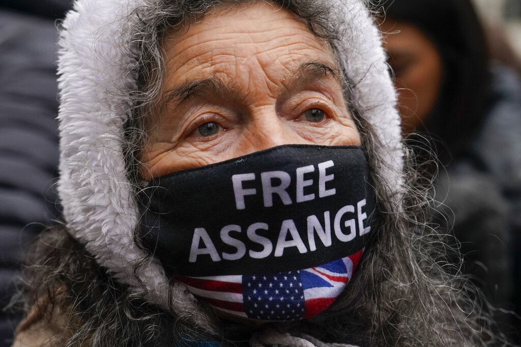 A supporter of Wikileaks founder Julian Assange stands outside the High Court, in London, Monday, Jan. 24, 2022. WikiLeaks founder Julian Assange has won the first stage of his effort to appeal a U.K. ruling that opened the door for his extradition to U.S. to stand trial on espionage charges. The High Court in London gave Assange permission appeal the case to the U.K. Supreme Court. (AP Photo/Alberto Pezzali)