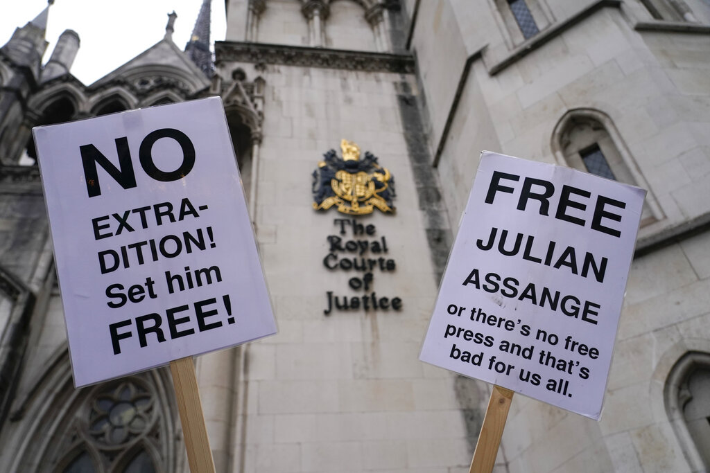 Placards in support of Julian Assange,  outside the High Court, in London, Monday, Jan. 24, 2022. WikiLeaks founder Julian Assange has won the first stage of his effort to appeal a U.K. ruling that opened the door for his extradition to U.S. to stand trial on espionage charges. The High Court in London gave Assange permission appeal the case to the U.K. Supreme Court. (AP Photo/Alberto Pezzali)