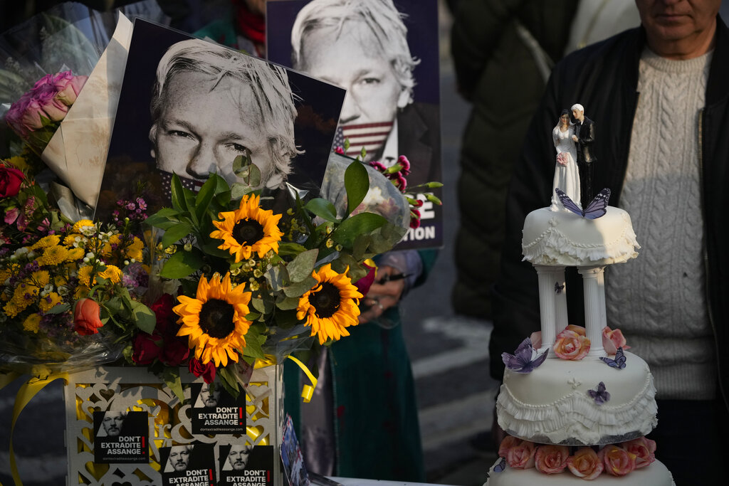 Figurines are displayed on a wedding cake before it was cut by Stella Moris after marrying her partner the WikiLeaks founder Julian Assange in a small wedding service held inside the high-security Belmarsh Prison, in south east London, Wednesday, March 23, 2022. Assange, who is in a legal battle over a decision to extradite him to the U.S. to face spying charges, has been held at Belmarsh Prison since 2019, when he was arrested for skipping bail during a separate legal battle. Before that, he spent seven years inside the Ecuadorian Embassy in London to avoid extradition to Sweden to face allegations of rape and sexual assault. (AP Photo/Matt Dunham)