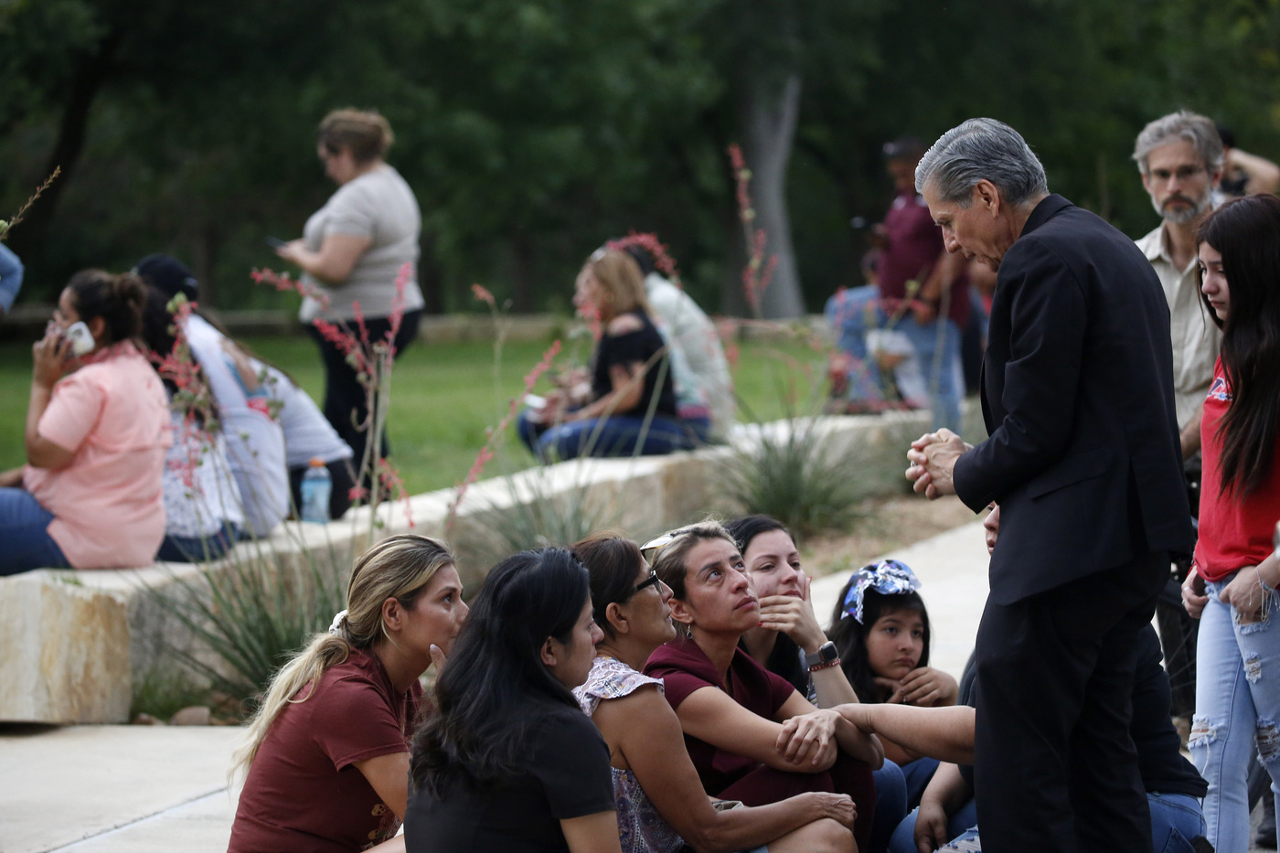 CORRECTS SPELLING TO GARCIA-SILLER, INSTEAD OF GARCIA SELLER - The archbishop of San Antonio, Gustavo Garcia-Siller, right, comforts families outside the Civic Center following a deadly school shooting at Robb Elementary School in Uvalde, Texas, Tuesday, May 24, 2022. (AP Photo/Dario Lopez-Mills)