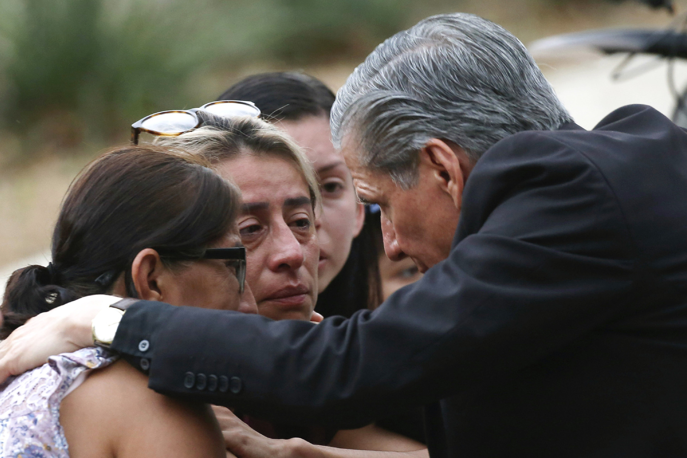 CORRECTS SPELLING TO GARCIA-SILLER, INSTEAD OF GARCIA SELLER - The archbishop of San Antonio, Gustavo Garcia-Siller, comforts families outside the Civic Center following a deadly school shooting at Robb Elementary School in Uvalde, Texas, Tuesday, May 24, 2022. (AP Photo/Dario Lopez-Mills)