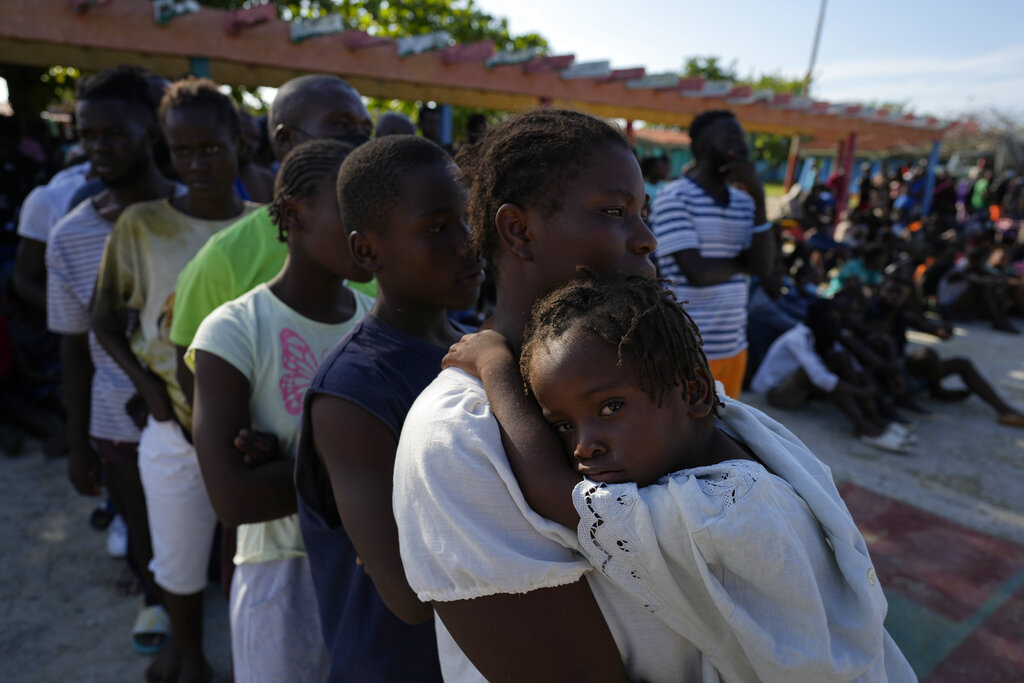 Haitians wait to be processed and get medical attention at a tourist campground in Sierra Morena, in the Villa Clara province of Cuba, Wednesday, May 25, 2022. A vessel carrying more than 800 Haitians trying to reach the United States wound up instead on the coast of central Cuba, government news media said Wednesday. (AP Photo Ramon Espinosa)