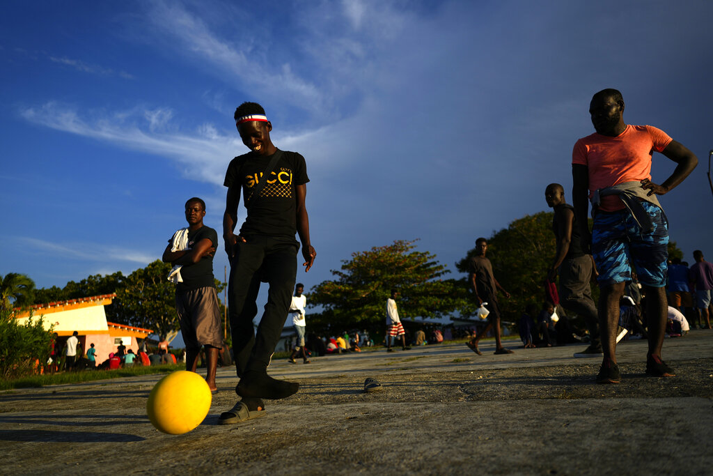 Haitian migrants play a pick up game of soccer at a tourist campground in Sierra Morena, in the Villa Clara province of Cuba, Wednesday, May 25, 2022. A vessel carrying more than 800 Haitians trying to reach the United States wound up instead on the coast of central Cuba, government news media said Wednesday. (AP Photo Ramon Espinosa)