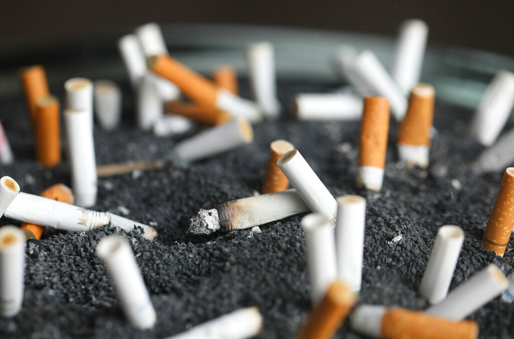 FILE - This March 28, 2019 photo shows cigarette butts in an ashtray in New York. On Tuesday, March 9, 2021. Lung cancer is the nation’s top cancer killer, causing more than 135,000 deaths each year. Smoking is the chief cause and quitting the best protection. (AP Photo/Jenny Kane, File)