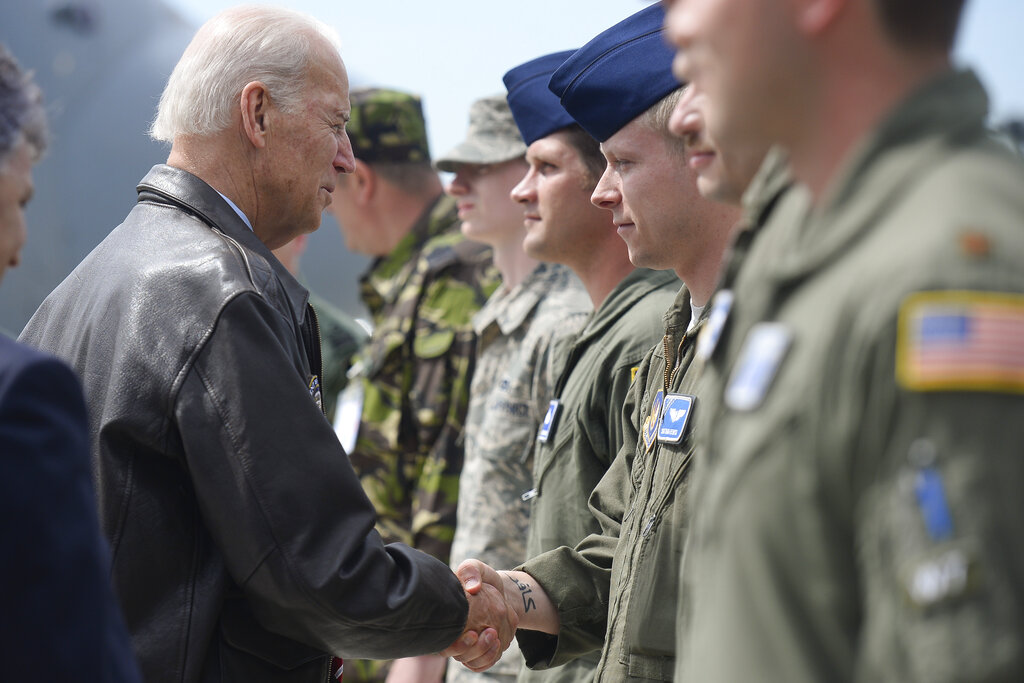 US Vice President Joe Biden shakes hands with Romanian an airforce soldier during a joint American-Romanian military event at the Otopeni Airbase, in Otopeni, Romania, Tuesday, May 20, 2014. Biden is on a two-day official visit to Romania.(AP Photo/Octav Ganea, Mediafax) ROMANIA OUT