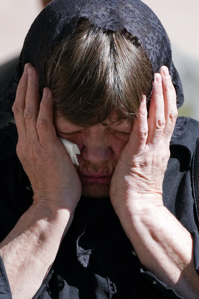 A relative of Army Col. Oleksander Makhachek mourns during a funeral service in Zhytomyr, Ukraine, Friday, June 3, 2022. According to combat comrades Makhachek was killed fighting Russian forces when a shell landed in his position on May 30. (AP Photo/Natacha Pisarenko)