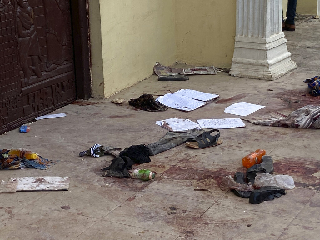 Personal belongings and shoes lie on the pavement of St. Francis Catholic Church in Owo Nigeria, Sunday, June 5, 2022. Lawmakers in southwestern Nigeria say more than 50 people are feared dead after gunmen opened fire and detonated explosives at a church. Ogunmolasuyi Oluwole with the Ondo State House of Assembly said the gunmen targeted the St Francis Catholic Church in Ondo state on Sunday morning just as the worshippers gathered for the weekly Mass. (AP Photo/Rahaman A Yusuf)