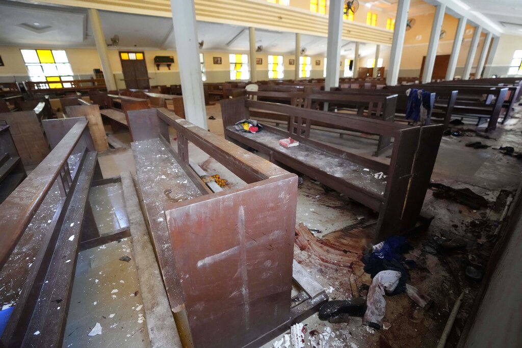 Personal belongings and shoes lie on the ground of St. Francis Catholic Church in Owo, Nigeria, Monday, June 6, 2022, a day after an attack that targeted worshipers. The gunmen who killed 50 people at a Catholic church in southwestern Nigeria opened fire on worshippers both inside and outside the building in a coordinated attack before escaping the scene, authorities and witnesses said Monday. (AP Photo/Sunday Alamba)