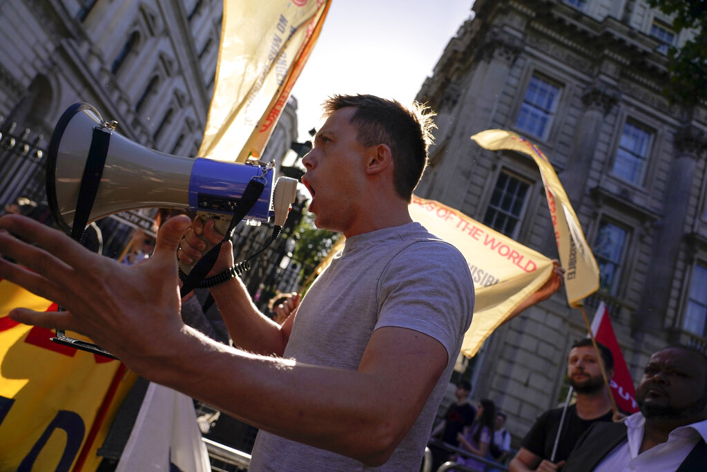 People attend a workers protest outside the gates of Downing Street, in London, Friday, May 27, 2022. An investigative report released Wednesday blamed British Prime Minister Boris Johnson and other senior leaders for allowing boozy government parties that broke the U.K.'s COVID-19 lockdown rules, and while Johnson said he took 