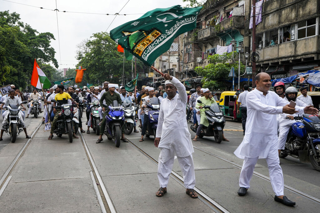Indian Muslims block road as they protest against the spokesperson of governing Hindu nationalist party as they react to the derogatory references to Islam and the Prophet Muhammad in Kolkata, India, Friday, June 10, 2022. Thousands of Muslims emerging from mosques after Friday prayers held street protests and hurled rocks at the police in some Indian towns and cities over remarks by two officials from India’s ruling party that were derogatory to the Prophet Muhammad.  (AP Photo/Bikas Das)