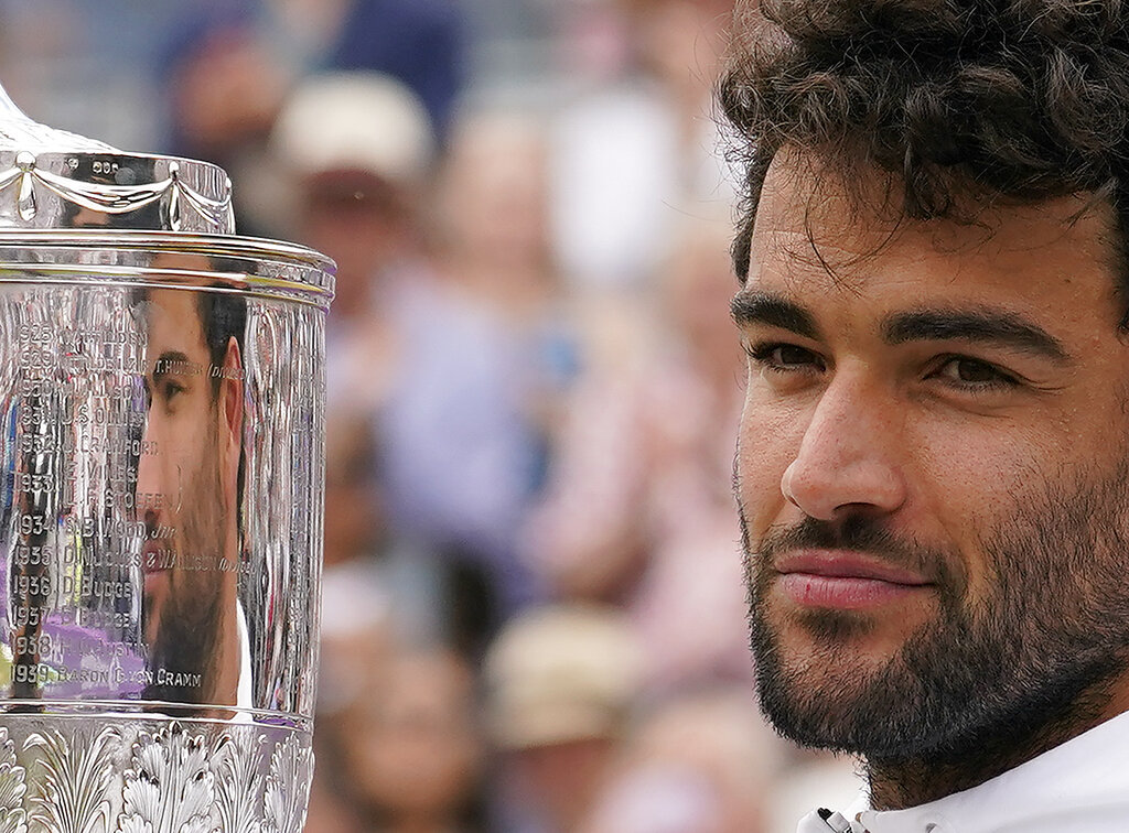 Italy's Matteo Berrettini celebrates with the trophy after beating Serbia's Filip Krajinovic to win the final tennis match at the Queen's Club Championships in London, Sunday, June 19, 2022. (AP Photo/Alberto Pezzali)