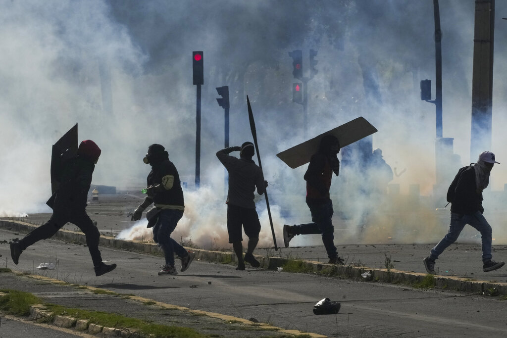 Demonstrators clash with police during protests against President Guillermo Lasso's economic policies and demanding a fuel price cut, in downtown Quito, Ecuador, Thursday, June 23, 2022. (AP Photo/Dolores Ochoa)