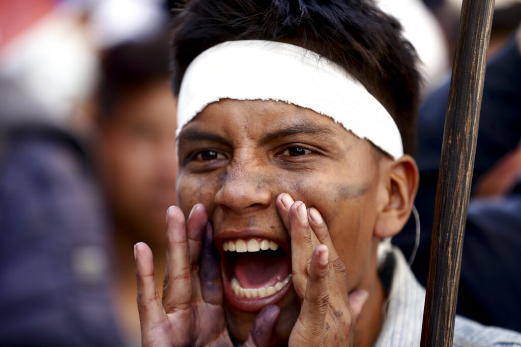 A demonstrator shouts during a protest in downtown Quito, Ecuador, Wednesday, June 22, 2022. Protests by Indigenous people demanding a variety of changes, including lower fuel prices, have paralyzed Ecuador's capital and other regions. (AP Photo/Juan Diego Montenegro)
