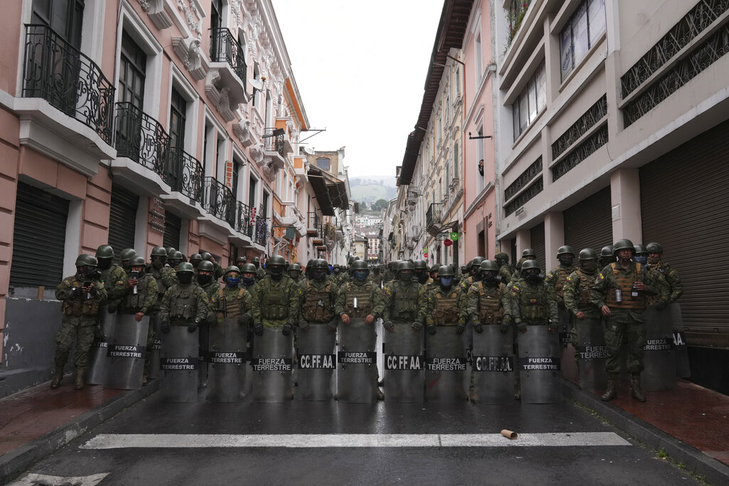 Security forces block protesters from marching to the presidential palace in Quito, Ecuador, Wednesday, June 22, 2022. Protests by Indigenous people demanding a variety of changes, including lower fuel prices, have paralyzed Ecuador's capital and other regions, but the government on Wednesday rejected their conditions for dialogue. (AP Photo/Dolores Ochoa)