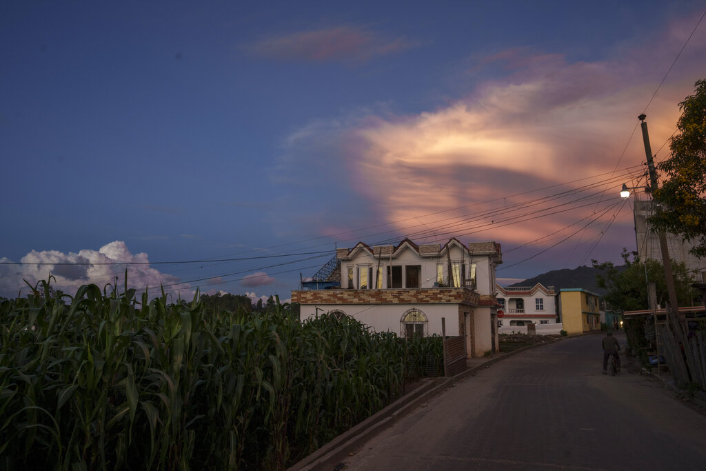 Houses built by migrants are surrounded by corn fields, in Tzucubal, Guatemala, Wednesday, June 29, 2022. Tzucubal is the hometown of Pascual Melvin Guachiac and Wilmer Tulul, both 13, who were among the dead discovered inside a tractor-trailer on the edge of San Antonio, Texas, on Monday, in one of the nation's deadliest smuggling episode on the U.S.-Mexico border. (AP Photo/Moises Castillo)